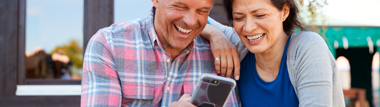 Hispanic Couple on their Mobile phone