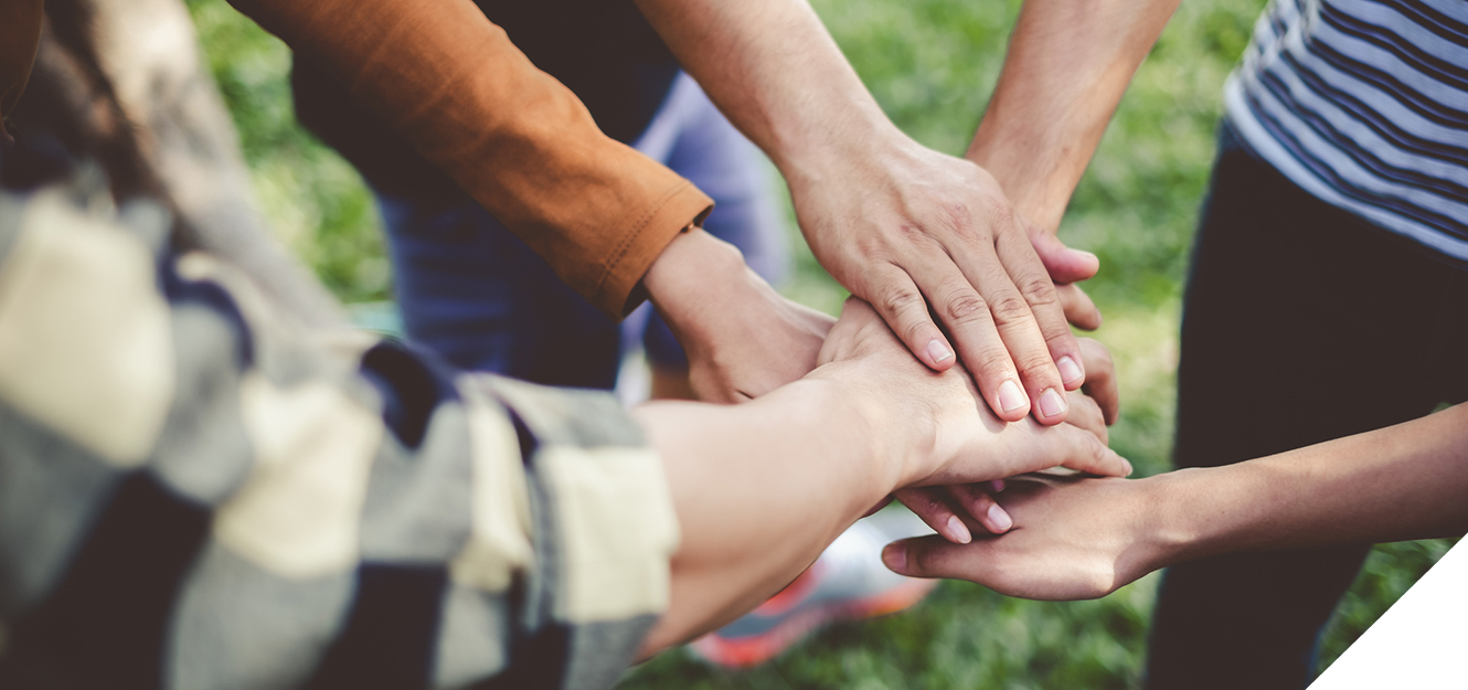 People stacking hands in team unity