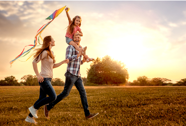 Father, mother, and child flying a kit