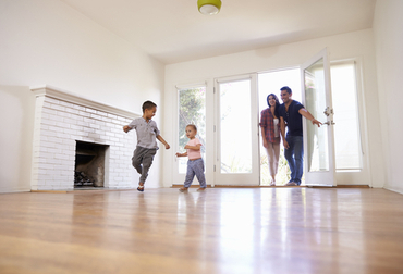 Mom Dad and 2 kids entering their new home