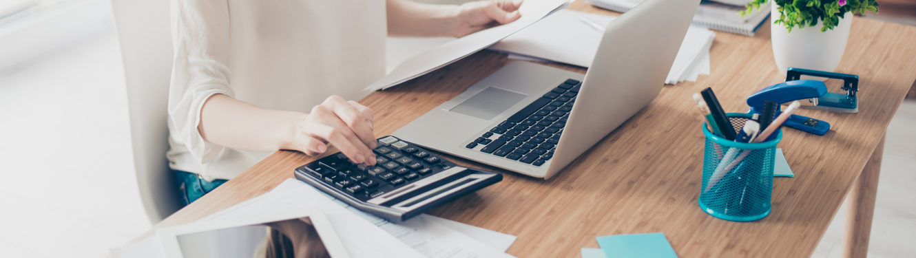 Woman hand using a calculator.