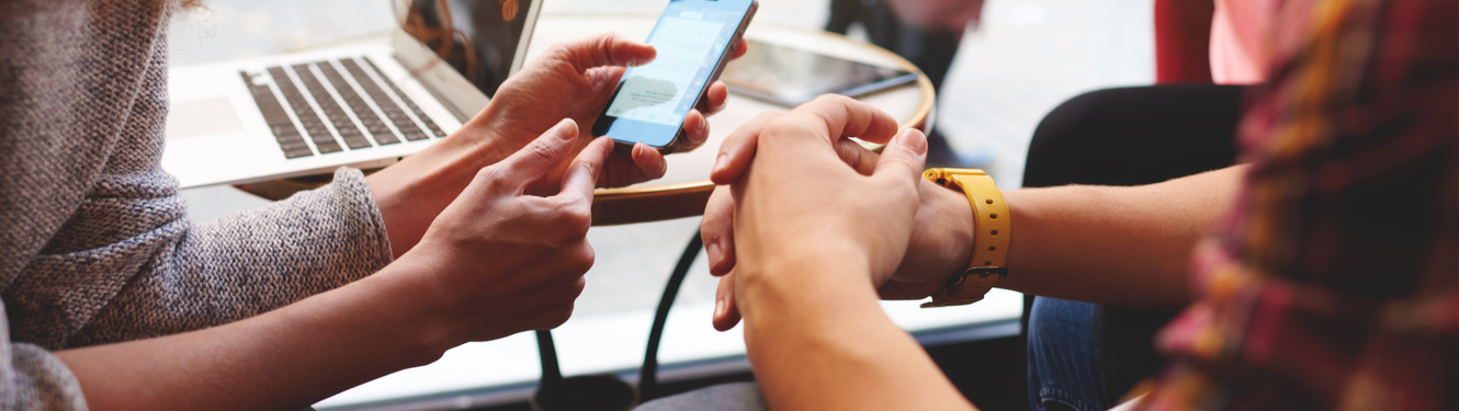 2 people looking at a mobile phone app.